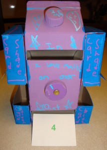 Purple math machine with card coming out with the answer 4