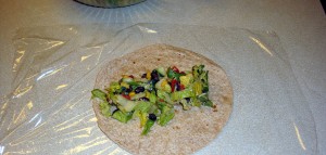 wrap ingredients on the tortilla, which is on a large piece of Saran Wrap or plastic wrap